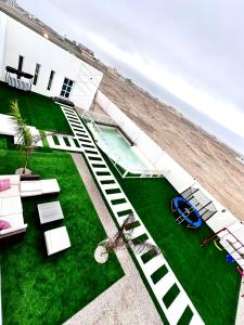 an aerial view of a house with a swimming pool and the beach at استراحة لالونا in Salalah