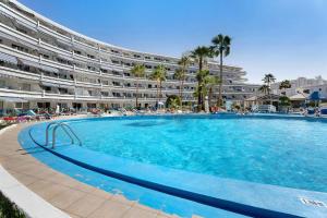 a large swimming pool in front of a large apartment building at Sia Bungalow Sunset View in Adeje
