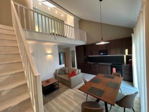 a living room with a table and a kitchen at Charming Apartment in Lubin