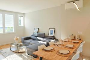 a living room with a table and a couch at Chez Barrau - Confort et charme au cœur de Lourdes in Aspin-en-Lavedan