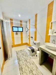 a bathroom with a toilet and a sink at LD1.House Private Room,Thapae Gate, Chiang Mai Old city in Chiang Mai