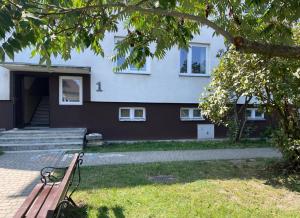 a park bench sitting in front of a house at es studio in Staszów