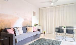 a living room with a couch and a table at CSS Cute Superior King's Palace in Paphos City