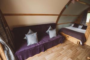 a room with a couch and a bed with pillows at Brecon by Wigwam Holidays in Brecon