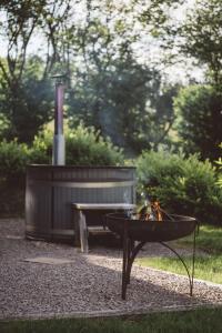 a fire pit and a bench in a park at Brecon by Wigwam Holidays in Brecon