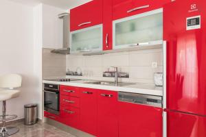 a kitchen with red cabinets and a sink at Deluxe Apartment Manuela With Balcony Top Center Split in Split