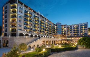 a large building with lights in front of it at SH Dolce Vita- All Inclusive - Free Aquapark & Beach & Beach bar in Golden Sands