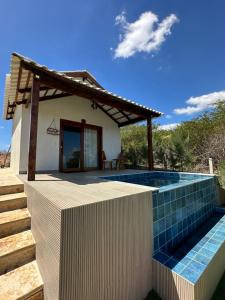 a villa with a swimming pool and a house at Prainha do Jet in Tianguá