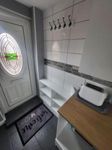 a small kitchen with a counter and a window at Birkdale's Hidden Gem in Southport +8 photos