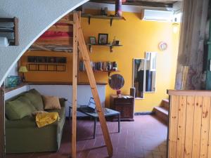 a living room with a couch and a bunk bed at Pilgrims Corner in Campagnano di Roma