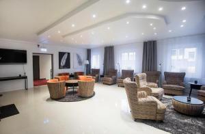 a large living room with chairs and a table at Kungsbacken Hotell & Konferens in Katrineholm