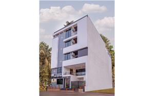 an architectural rendering of a white building with trees in the foreground at Hotel Dream Inn in Mānglia