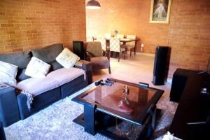 a living room with a couch and a coffee table at Casas perto cervejaria 3 Santas in Santa Teresa