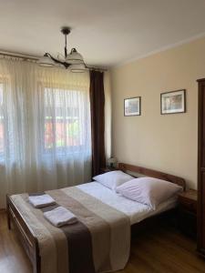 Postel nebo postele na pokoji v ubytování Pokoje Sylwia z aneksami kuchennymi w każdym pokoju