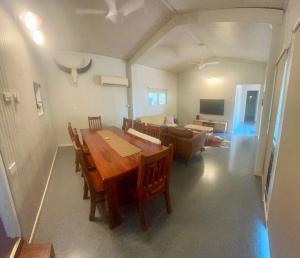 a living room with a wooden table and a couch at The Quarters in Katherine