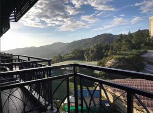 a balcony with a view of a river and mountains at Cameron Nova Highlands Resorts II in Brinchang