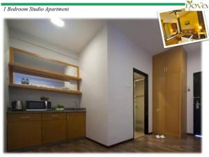 a room with a kitchen with a counter and a mirror at Cameron Nova Highlands Resorts II in Brinchang