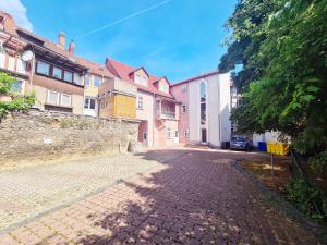 a cobblestone street in front of some buildings at DM Hotels & Apartments - Apartment Brückenstr 27 in Mühlhausen +2 photos