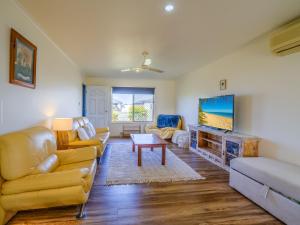 a living room with a couch and a tv at Close to Hospital. WiFi, DogsOk in Point Vernon