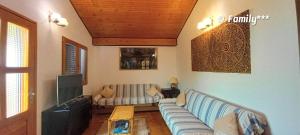 a living room with a couch and a tv at Family*** in Selce