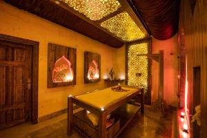 a room with a table with lights on the wall at Kapadokya Hill Hotel & Spa in Nevşehir +86 photos