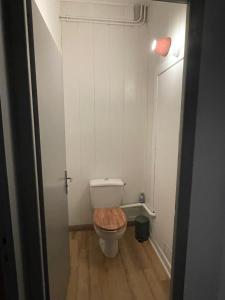 ein kleines Bad mit einem WC und einem Holzsitz in der Unterkunft Gîte en bord de lac in Monsireigne + 4 Fotos