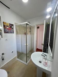 a bathroom with a shower and a sink at Luz, sol y arena in Rota