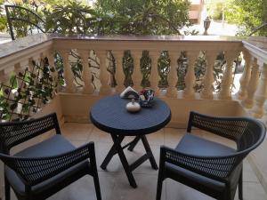 a table and four chairs on a balcony at Double room in Villa Narges New Cairo in Cairo +8 photos
