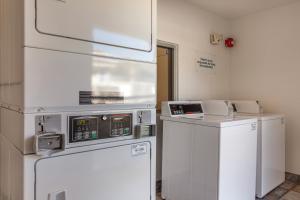 a kitchen with a refrigerator and a washing machine at Motel 6-Phoenix, AZ - North Bell Road in Phoenix