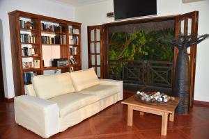 a living room with a couch and a table at Résidences-Bel-R in Nosy Be
