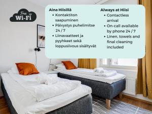 two beds in a room with descriptions of the room at Hiisi Homes Tampere Muotiala in Tampere +55 photos