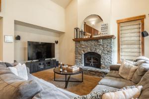 a living room with a couch and a fireplace at Lodges 1156 in Mammoth Lakes