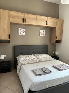 a bedroom with a bed with two towels on it at Affittacamere Home&Stazione Bologna in Bologna