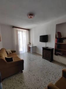 a living room with a couch and a flat screen tv at casa vacanza pacentro in Pacentro