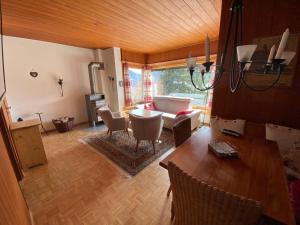 a living room with a table and a couch at Tga Muntanela in Savognin
