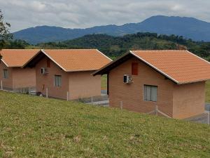 a row of houses with orange roofs on a hill at Kiebitz Haus in Pomerode +4 photos