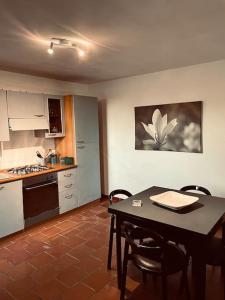 a kitchen with a table and chairs in a room at EKATOS- Polignano a Mare casa in campagna in Triggianello