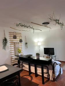 a living room with a table and a tv at EKATOS- Polignano a Mare casa in campagna in Triggianello +14 photos
