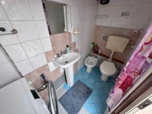 a small bathroom with a sink and a toilet at Beach House Sperlonga with Free Parking in Sperlonga +10 photos