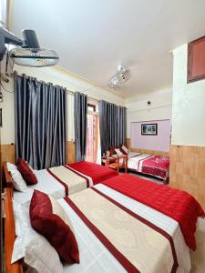 a bedroom with two beds with red pillows at New Nhat Minh HomeStay & Tour in Ninh Binh +80 photos