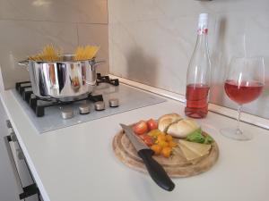 a table with a plate of food and a glass of wine at Cosy seaside family apartment Iris in Mandre in Mandre +18 photos