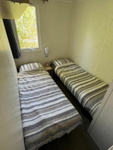 Letto o letti in una camera di Low Budget - 4 persoons chalet aan het Lauwersmeer
