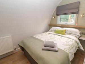 a small bedroom with a bed and a window at Belles View in Cheadle