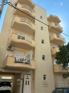 a building with balconies on the side of it at Blooming 31 AXD in Alexandroupoli