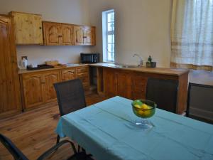 a kitchen with a table with a bowl of fruit on it at Lilibet Lodge in Graaff-Reinet