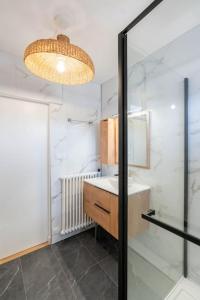 a bathroom with a sink and a mirror at T2 parking gratuit plus 2 balcons in Aix-les-Bains