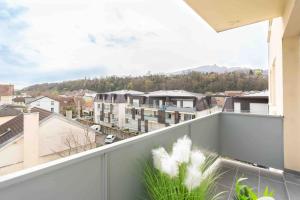 a balcony with a view of a city at T2 parking gratuit plus 2 balcons in Aix-les-Bains