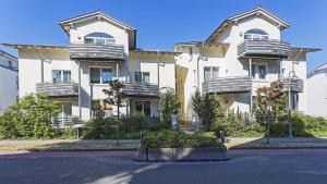 an apartment building with balconies on a street at Haus A Cappella B6 in Binz