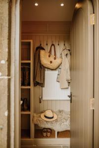 a walk in closet with a hat and purses at Lyme Tree Farm Cottages - Hotching Barn and Knockstone Cottage in Tideswell