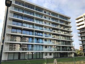 an apartment building with a lot of windows at Zee en Strand in De Panne